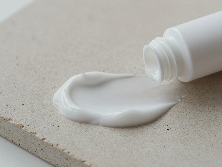 A swirl of moisturiser on a stone surface.